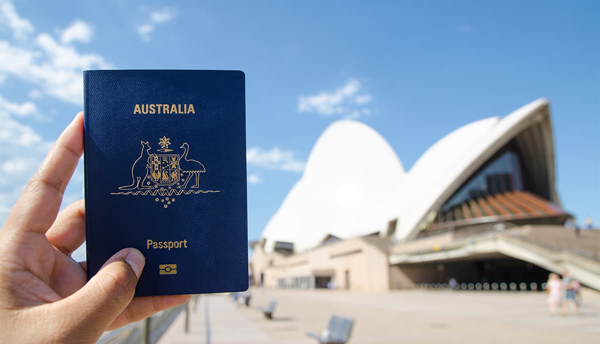 Australian passport held in front of the Sydney Opera House